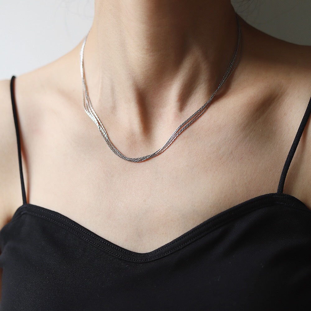 Multi-Layer 18K Gold-Plated Necklace, crafted in titanium steel with a sleek design. Weighs 6g, hypoallergenic, tarnish-free, and water-resistant. Delivered in Sutra Designs' custom packaging for an elegant presentation