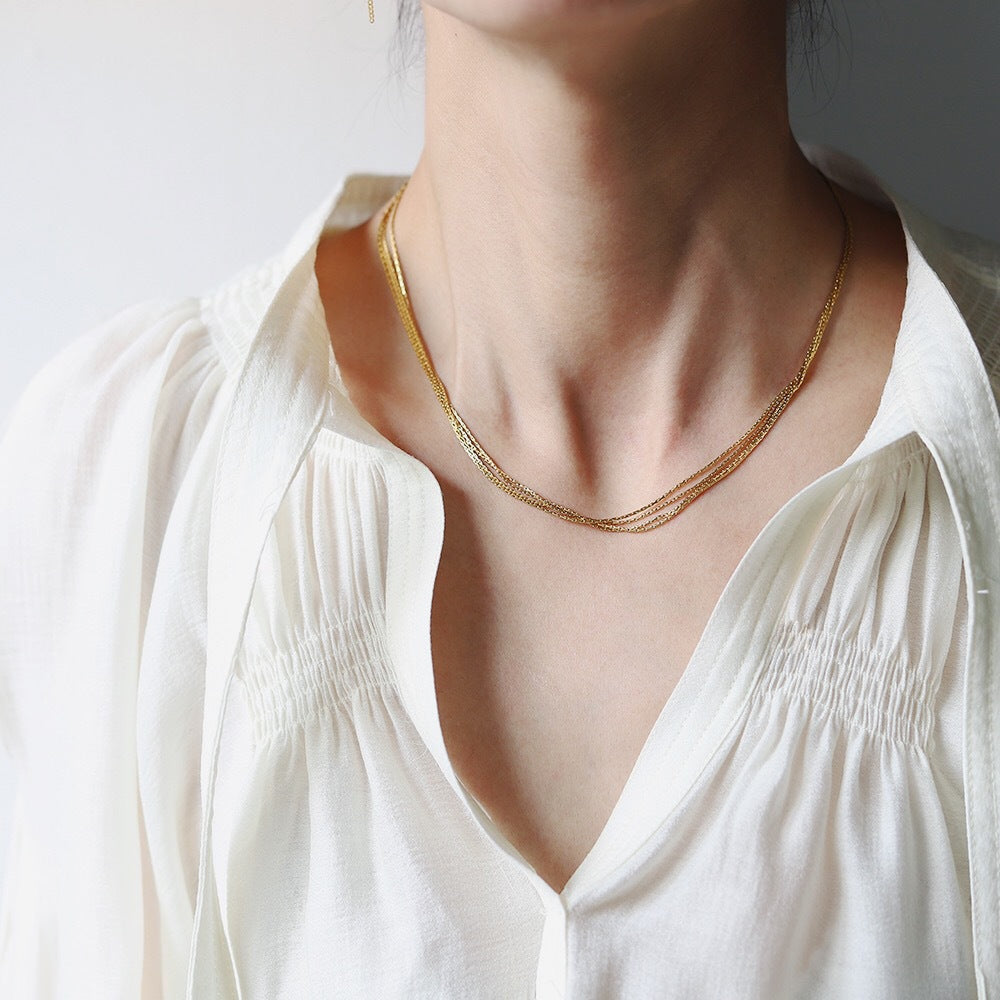 Multi-Layer 18K Gold-Plated Necklace, crafted in titanium steel with a sleek design. Weighs 6g, hypoallergenic, tarnish-free, and water-resistant. Delivered in Sutra Designs' custom packaging for an elegant presentation
