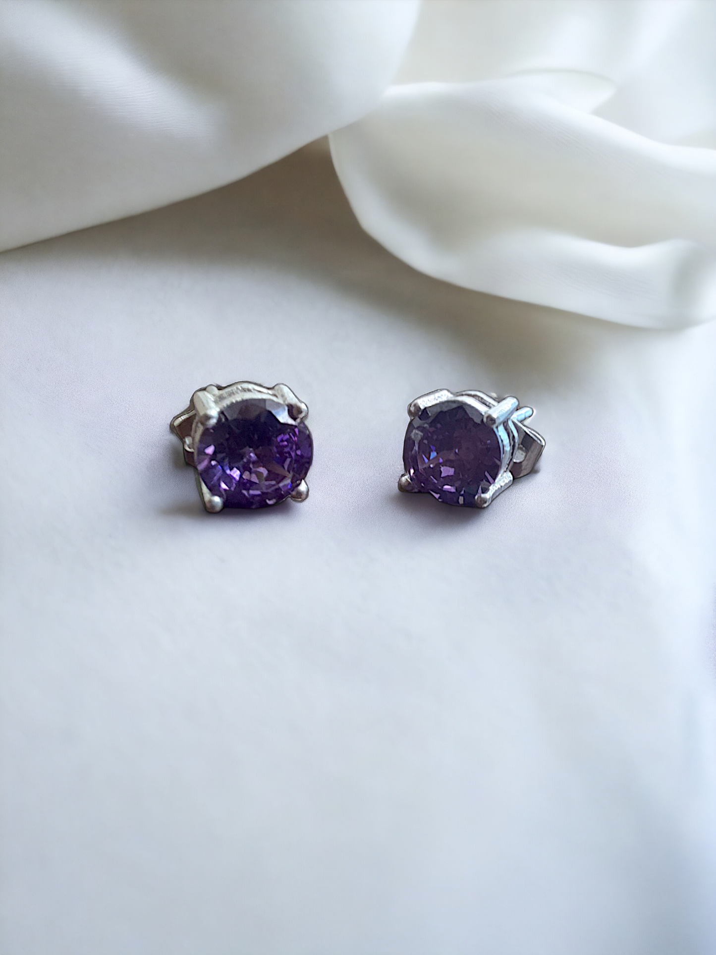 Purple Zircon Stud Earrings in silver, crafted from brass and featuring a 6mm purple zircon stone. Lightweight at 1.5g with skin-friendly material for comfort. Delivered in Sutra Designs' custom jewelry packaging, ensuring a luxurious finish