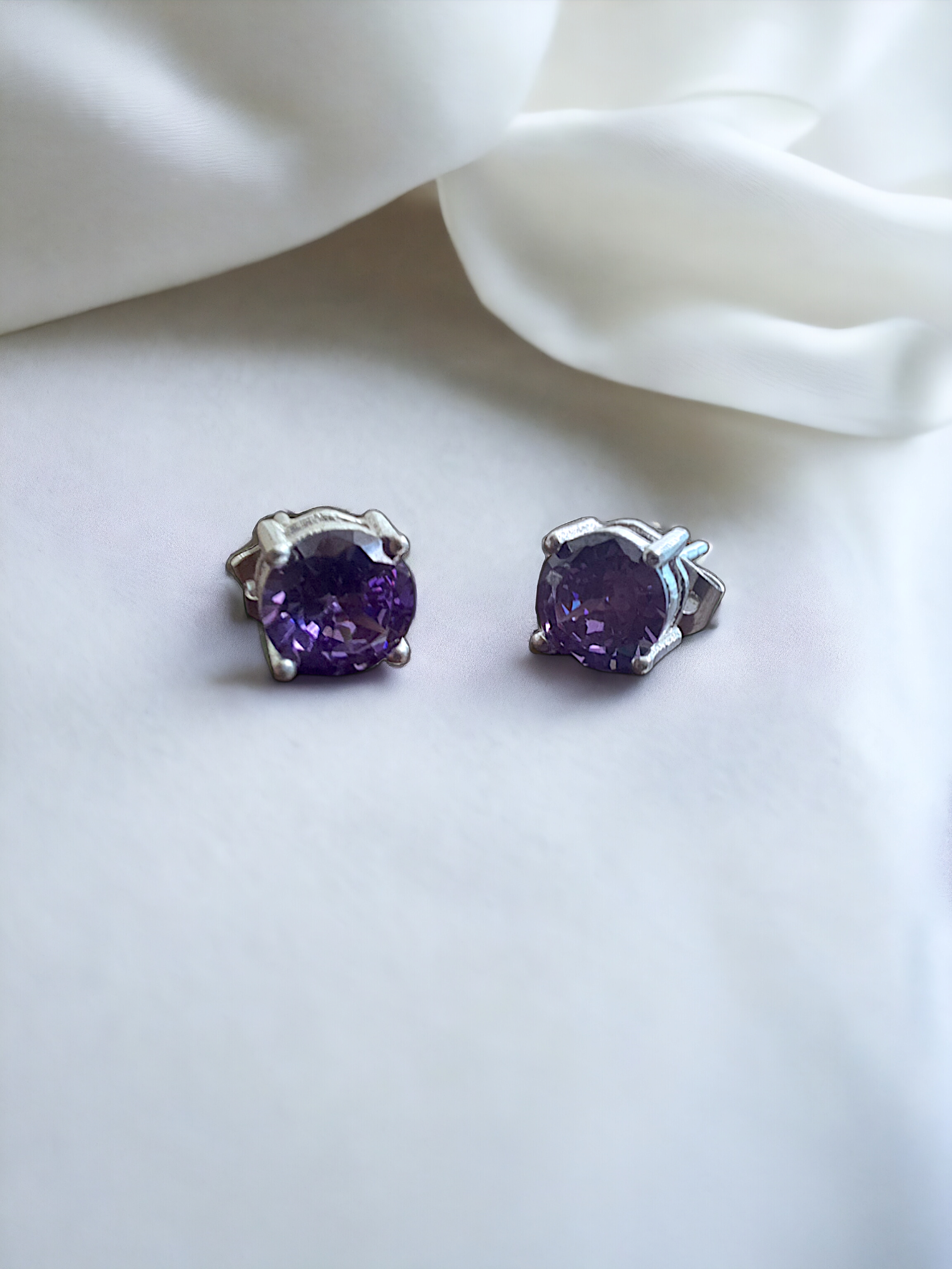 Purple Zircon Stud Earrings in silver, crafted from brass and featuring a 6mm purple zircon stone. Lightweight at 1.5g with skin-friendly material for comfort. Delivered in Sutra Designs' custom jewelry packaging, ensuring a luxurious finish