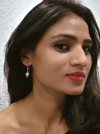 Mukta Pearl Hoop Earrings in Silver, crafted in brass with 8mm pearls. Elegant design with a lightweight feel, weighing just 2.4g. Skin-friendly material for comfort, delivered in Sutra Designs' custom jewelry packaging. A timeless accessory with a sophisticated touch