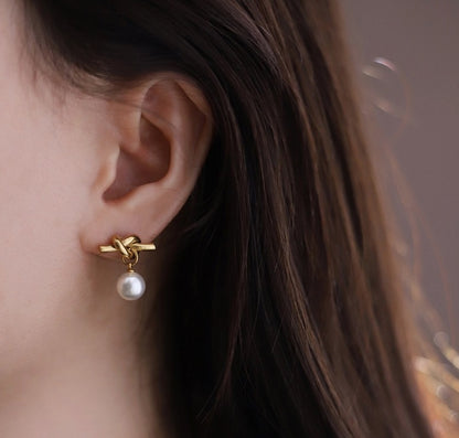 Pearl Drop 18K Gold-Plated Earrings, crafted from stainless steel with a sophisticated design. Features hypoallergenic material, tarnish-free finish, and water-resistance for durability. Measures 18.3mm x 16cm x 8mm and weighs 2.6g. Delivered in Sutra Designs' custom jewelry packaging for an elegant presentation