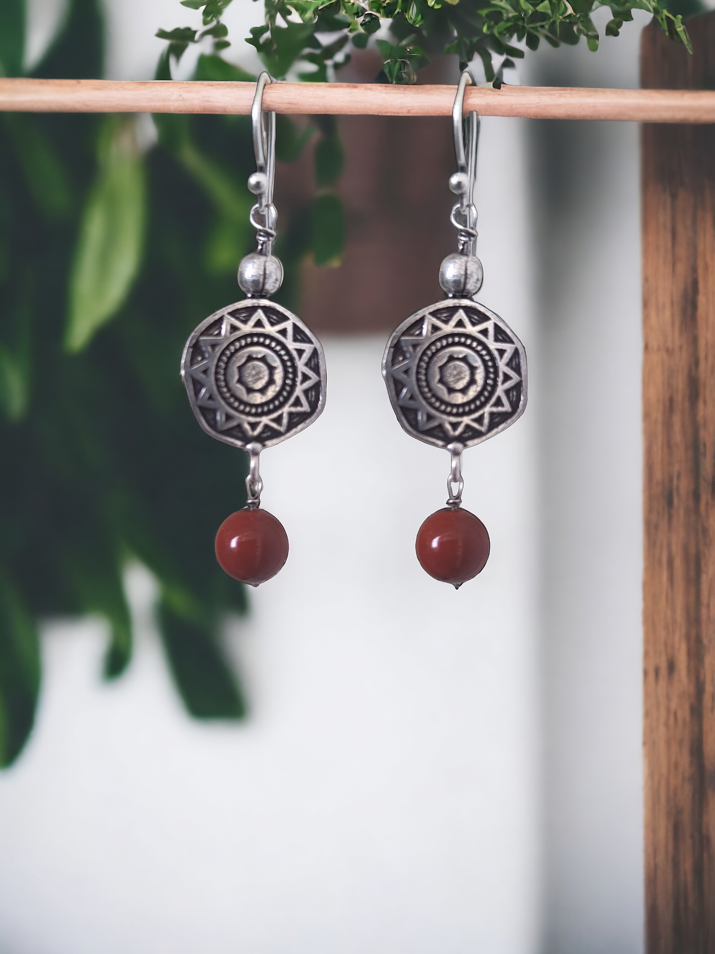 Rubina Red Jasper Charm Hoop Earrings in antique silver, crafted from brass and red jasper. Featuring a 1.5cm x 6mm design, these lightweight 5.6g earrings add a pop of color to any ensemble. Skin-friendly material ensures comfort, while their timeless charm makes them versatile for casual or elegant looks. Delivered in Sutra Designs' custom jewelry packaging for an added touch of luxury