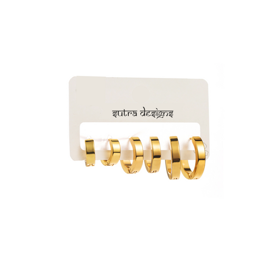 Set of 3 18K Gold Plated Hoop Earrings crafted in stainless steel. Includes sizes 1.6cm x 0.3cm, 1.3cm x 0.3cm, and 1.1cm x 0.3cm. Total weight 9g. These hypoallergenic, tarnish-free, and water-resistant earrings offer durable elegance for everyday wear. Versatile and perfect for layering or wearing individually, they add a chic touch to your wardrobe. Delivered in Sutra Designs' custom jewelry packaging for an extra special experience