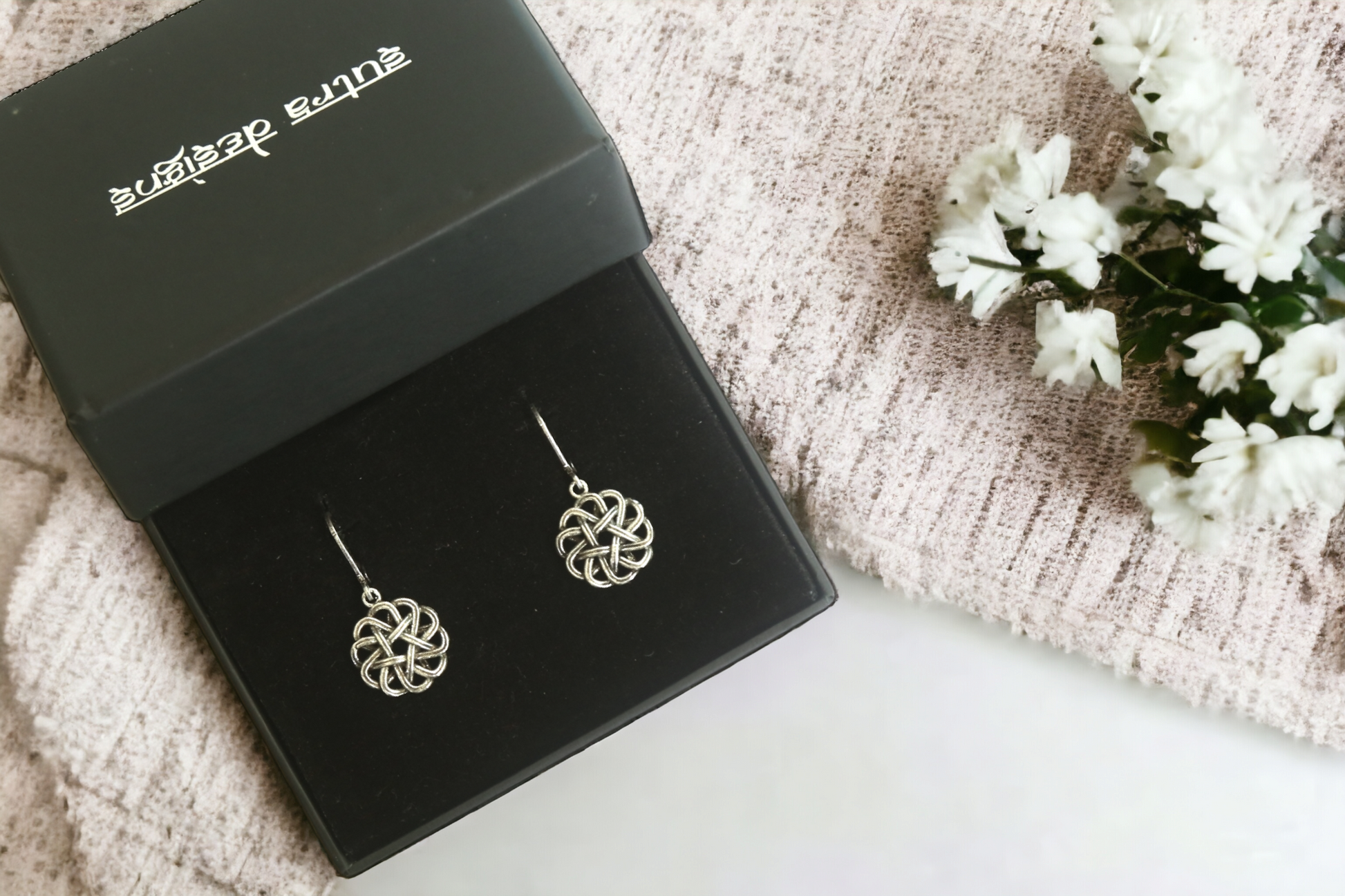 Krita Floral Charm Hoop Earrings in Antique Silver, crafted in brass with a 1.5cm charm size and a total weight of 4.1g. Skin-friendly material delivered in Sutra Designs' custom packaging