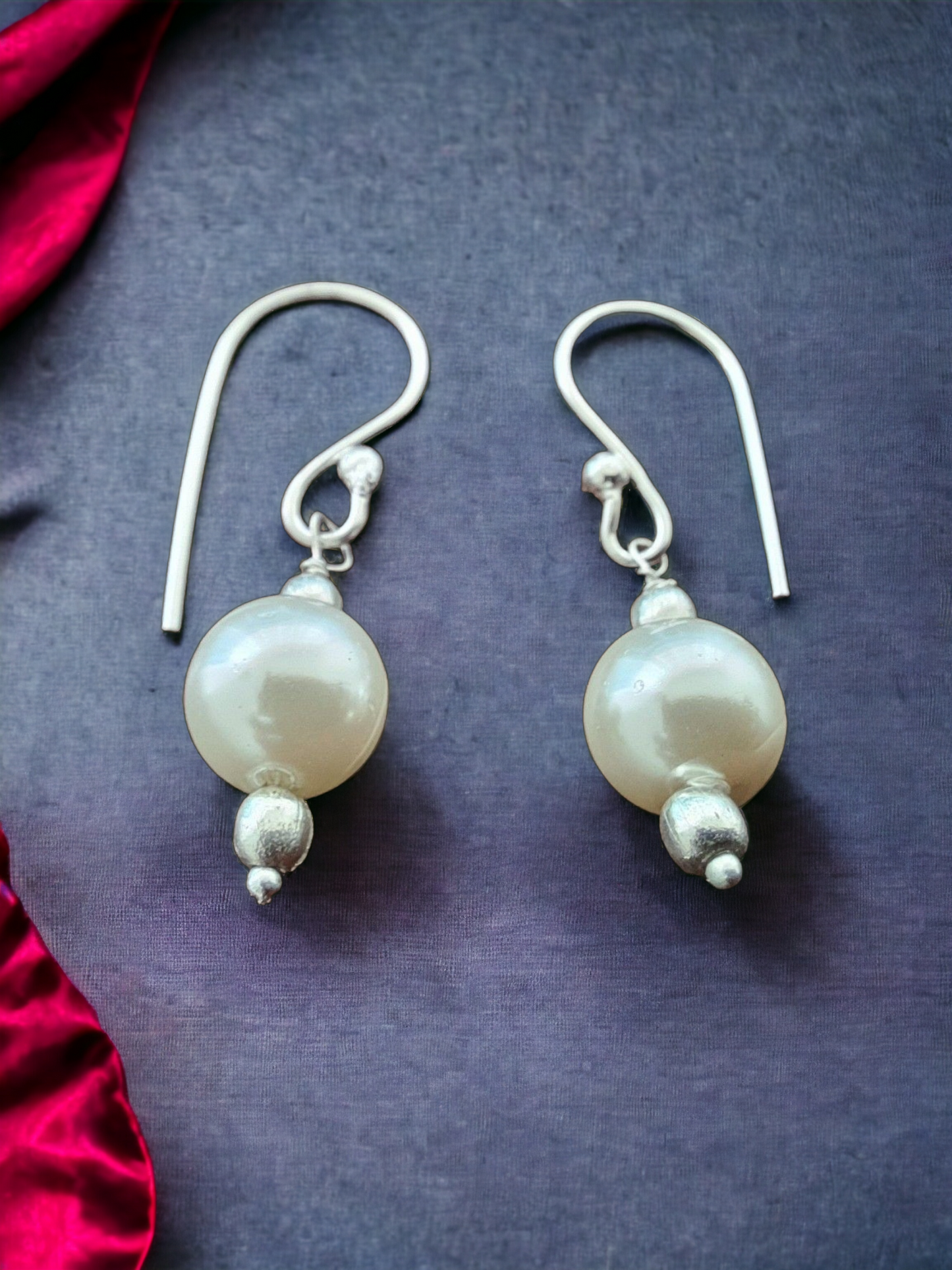 Mukta Pearl Hoop Earrings in Silver, crafted in brass with 8mm pearls. Elegant design with a lightweight feel, weighing just 2.4g. Skin-friendly material for comfort, delivered in Sutra Designs' custom jewelry packaging. A timeless accessory with a sophisticated touch