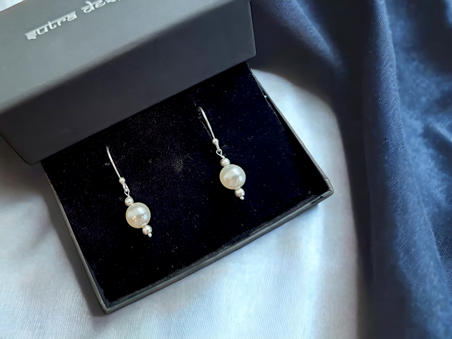Mukta Pearl Hoop Earrings in Silver, crafted from brass with 8mm pearls. Total weight of 2.4g. Skin-friendly material, delivered in Sutra Designs' custom packaging