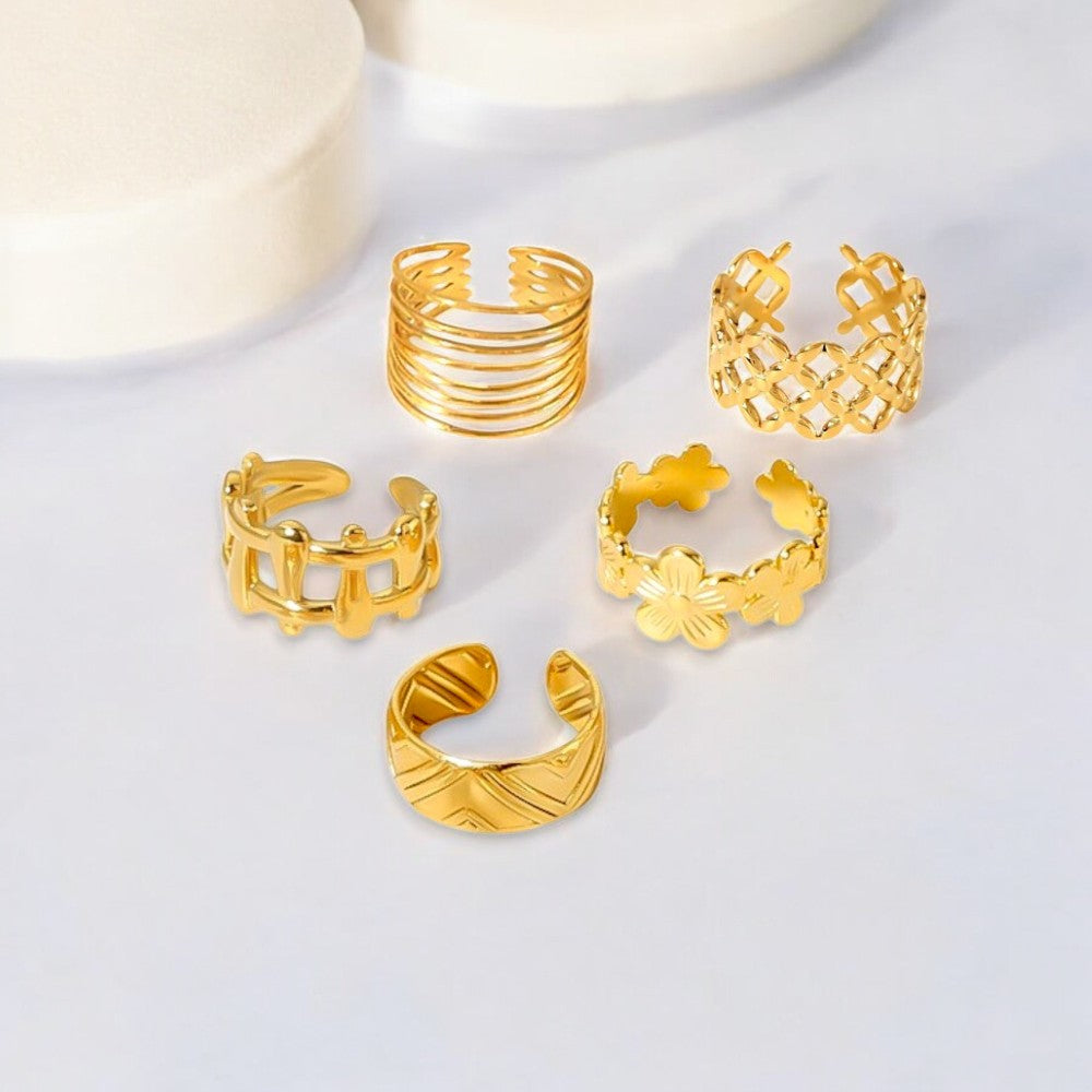 Set of 5 adjustable 18K Gold Plated rings crafted in stainless steel. Total weight 9.2g. These hypoallergenic, tarnish-free, and water-resistant rings offer exceptional durability and versatile styling. Perfect for stacking or wearing individually, they bring a sophisticated touch to your look. Delivered in Sutra Designs' custom jewelry packaging, ideal for gifting or elevating your own jewelry collection