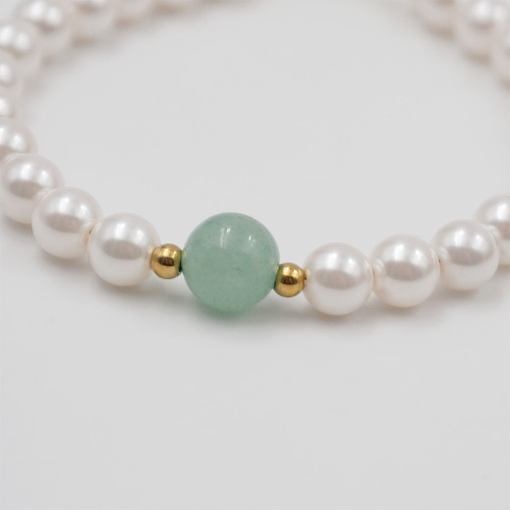 Elegant classical pearl and jade beaded handmade bracelet with gold-plated stainless steel accents. Adjustable size of 17 cm + 4 cm, weighing 10g. Hypoallergenic, tarnish-free, and designed for exceptional durability, this bracelet arrives in Sutra Designs’ custom jewelry packaging