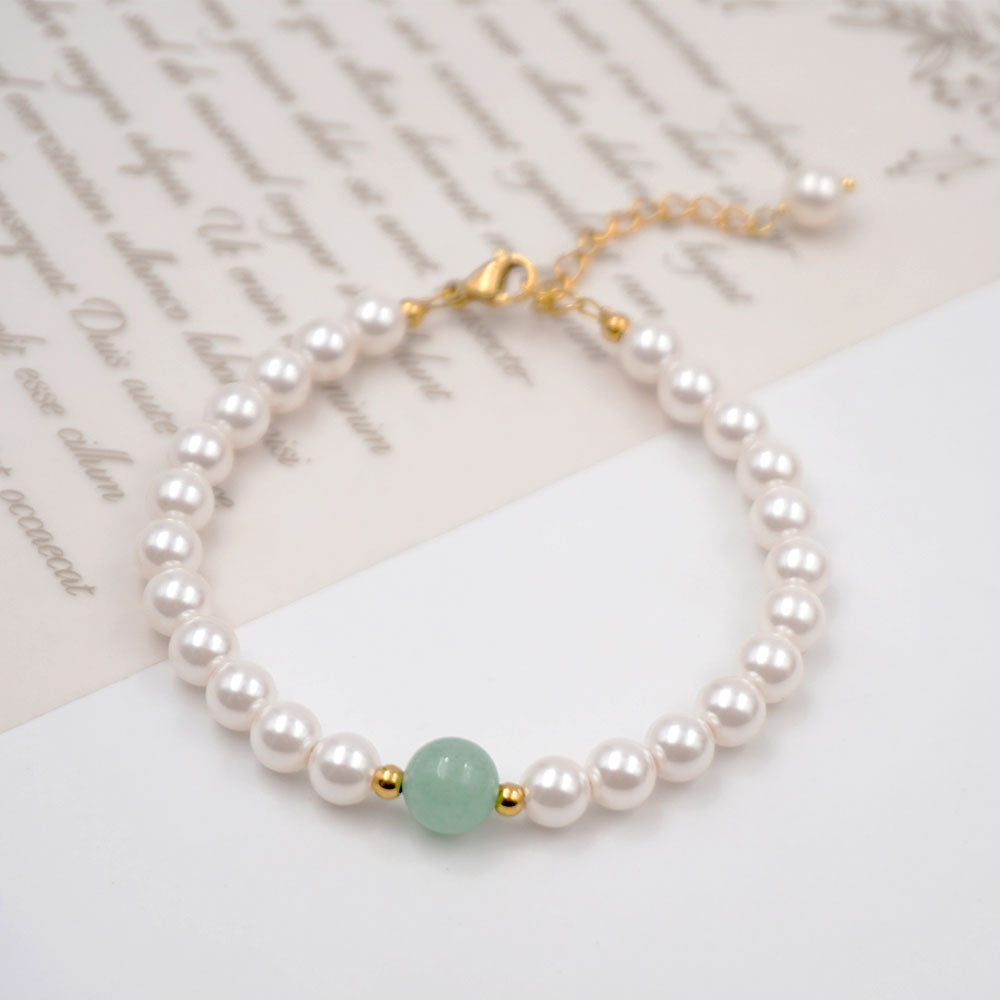 Elegant classical pearl and jade beaded handmade bracelet with gold-plated stainless steel accents. Adjustable size of 17 cm + 4 cm, weighing 10g. Hypoallergenic, tarnish-free, and designed for exceptional durability, this bracelet arrives in Sutra Designs’ custom jewelry packaging