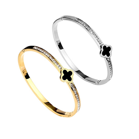 Hot Diamond Clover Open Bangle, 18K Gold-Plated and crafted in titanium steel with zirconia accents. Bracelet size 5.5cm, weighing 7g. Hypoallergenic, tarnish-free, water-resistant, and delivered in Sutra Designs' custom packaging