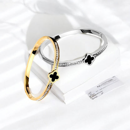 Hot Diamond Clover Open Bangle, 18K Gold-Plated and crafted in titanium steel with zirconia accents. Bracelet size 5.5cm, weighing 7g. Hypoallergenic, tarnish-free, water-resistant, and delivered in Sutra Designs' custom packaging