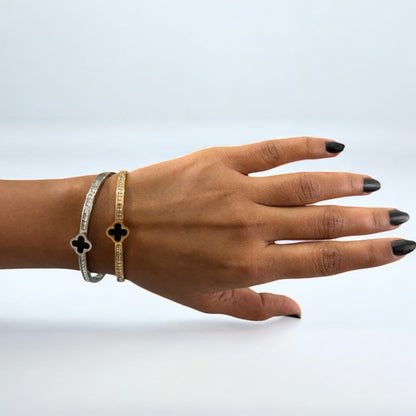 Hot Diamond Clover Open Bangle, 18K Gold-Plated and crafted in titanium steel with zirconia accents. Bracelet size 5.5cm, weighing 7g. Hypoallergenic, tarnish-free, water-resistant, and delivered in Sutra Designs' custom packaging