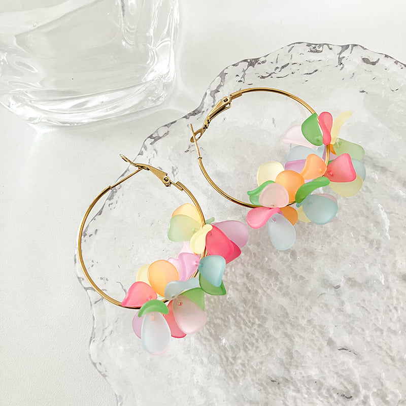 Elegant multi-color acrylic flower earrings with 14K gold plating, crafted from stainless steel, measuring 5.3 cm x 4 cm and weighing 10g. Vibrant hues in the floral design make these earrings stand out. Hypoallergenic, tarnish-free, and water-resistant, offering exceptional durability and a lasting shine. Delivered in Sutra Designs’ custom jewelry packaging, perfect for gifting or safekeeping