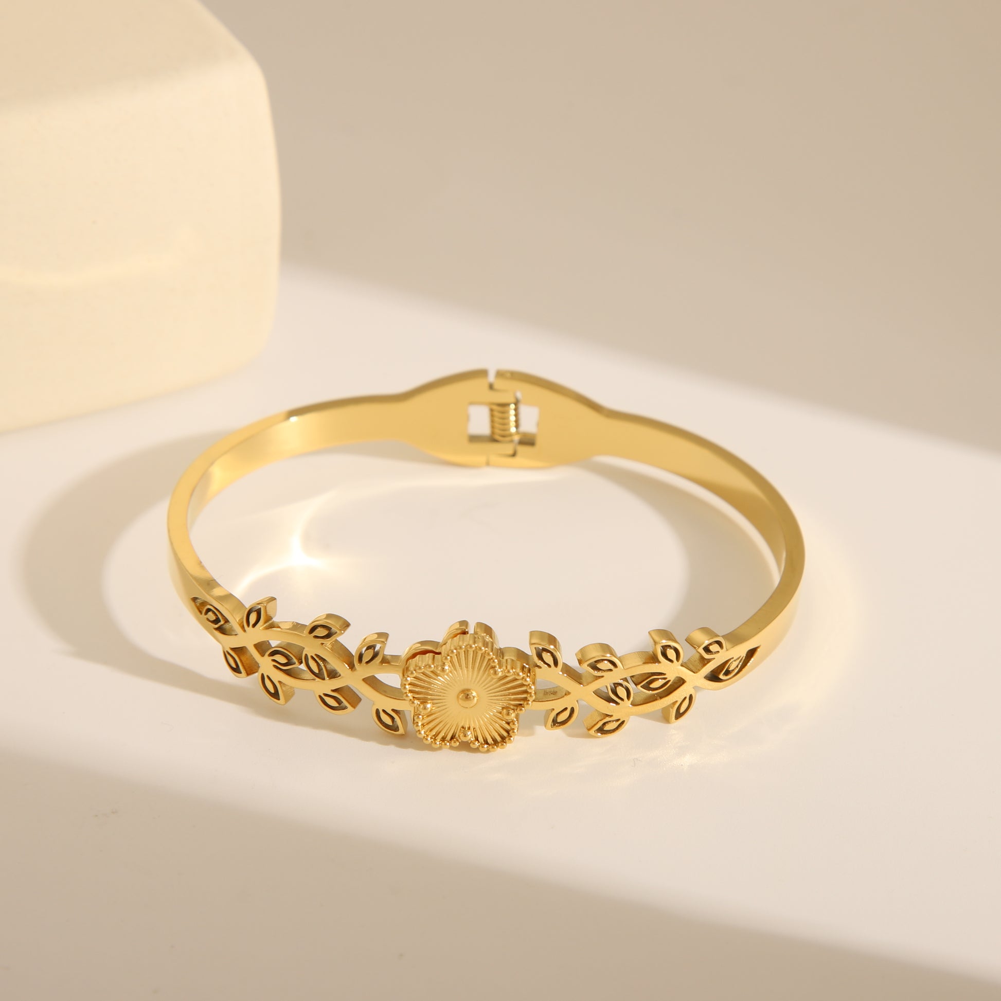 French Style Flower Open Bangle, 18K Gold-Plated, crafted from stainless steel and zirconia. Available in sizes 6cm and 5.9cm, with a weight of 18g. Hypoallergenic, tarnish-free, water-resistant, and delivered in Sutra Designs' custom packaging