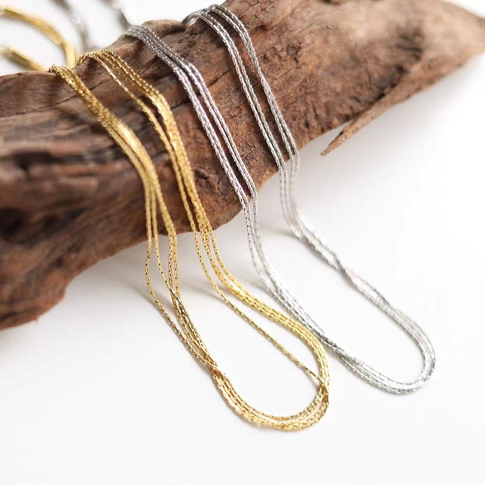Multi-Layer 18K Gold-Plated Necklace, crafted in titanium steel with a sleek design. Weighs 6g, hypoallergenic, tarnish-free, and water-resistant. Delivered in Sutra Designs' custom packaging for an elegant presentation
