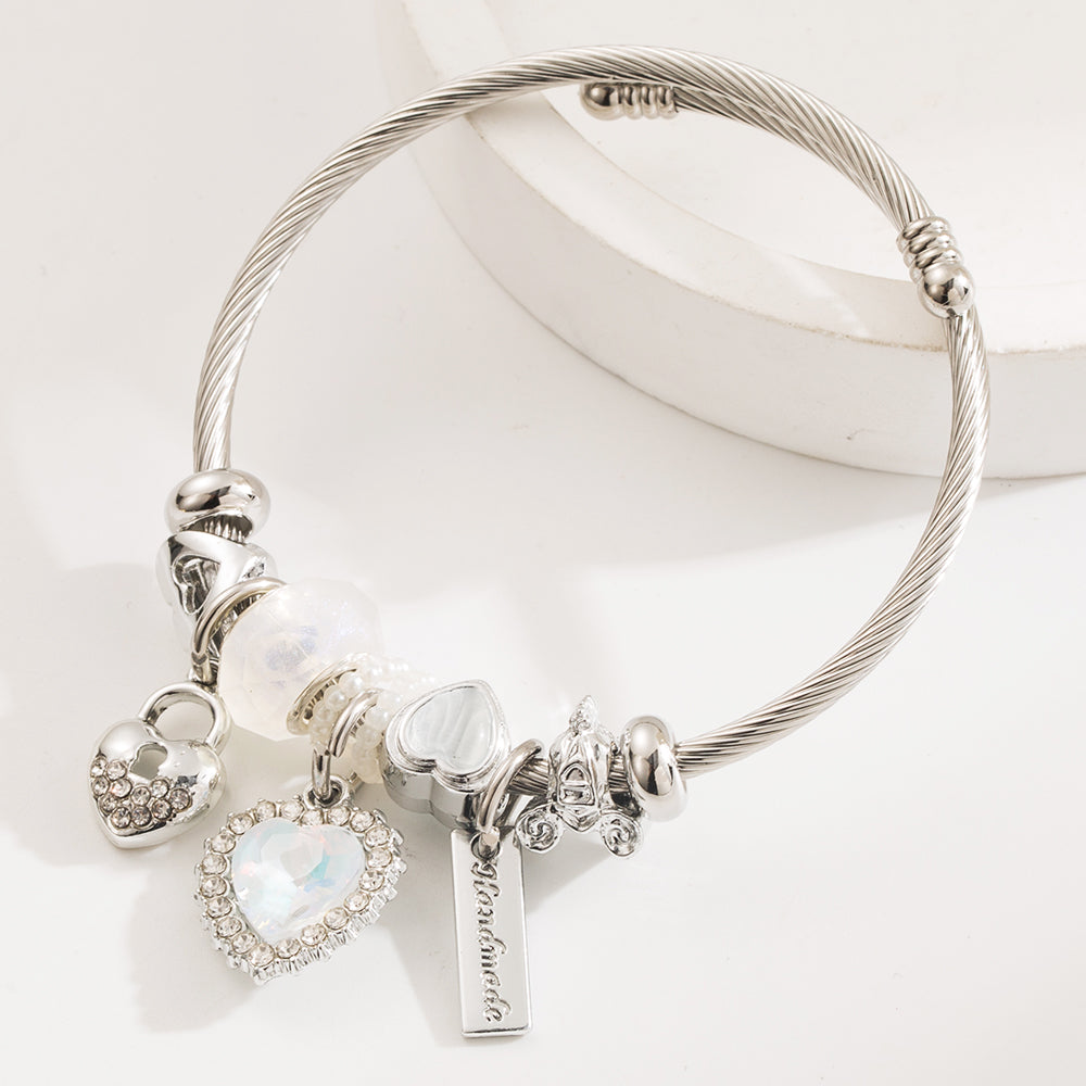 Elegant silver-plated heart-shaped bangle, crafted from durable stainless steel with an adjustable size of 5.5 cm, weighing 21g. Features hypoallergenic properties, tarnish-free finish, and exceptional durability for long-lasting wear. Delivered in Sutra Designs’ custom jewelry packaging, perfect for gifting or safekeeping