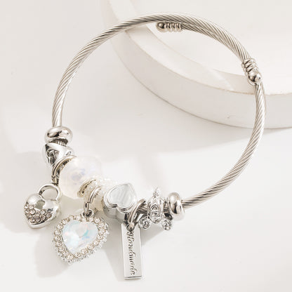 Elegant silver-plated heart-shaped bangle, crafted from durable stainless steel with an adjustable size of 5.5 cm, weighing 21g. Features hypoallergenic properties, tarnish-free finish, and exceptional durability for long-lasting wear. Delivered in Sutra Designs’ custom jewelry packaging, perfect for gifting or safekeeping