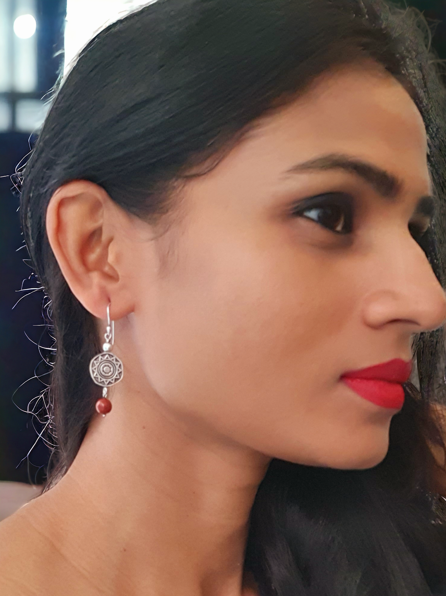 Rubina Red Jasper Charm Hoop Earrings in antique silver, crafted from brass and red jasper. Featuring a 1.5cm x 6mm design, these lightweight 5.6g earrings add a pop of color to any ensemble. Skin-friendly material ensures comfort, while their timeless charm makes them versatile for casual or elegant looks. Delivered in Sutra Designs' custom jewelry packaging for an added touch of luxury