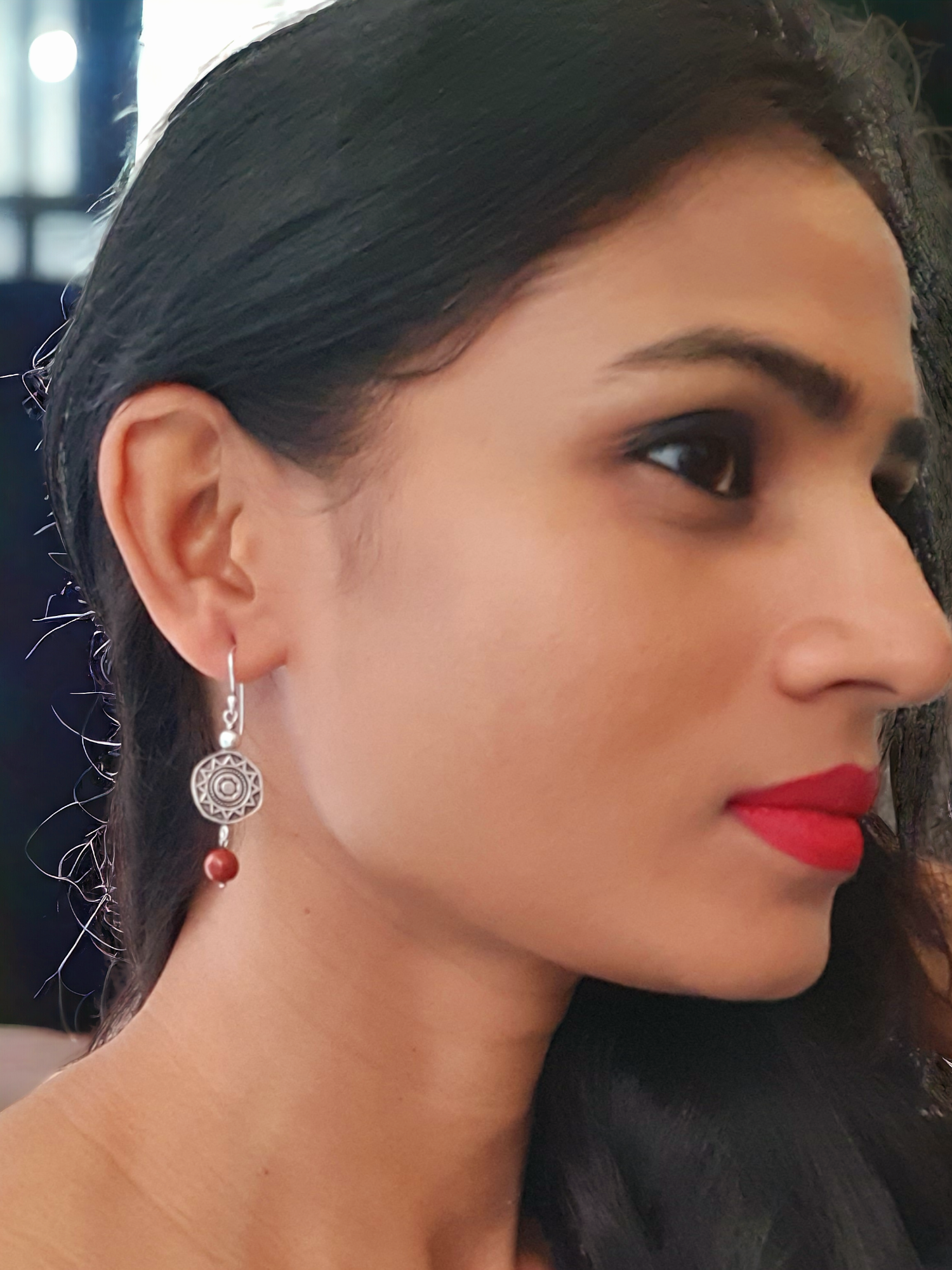 Rubina Red Jasper Charm Hoop Earrings in antique silver, crafted from brass and red jasper. Featuring a 1.5cm x 6mm design, these lightweight 5.6g earrings add a pop of color to any ensemble. Skin-friendly material ensures comfort, while their timeless charm makes them versatile for casual or elegant looks. Delivered in Sutra Designs' custom jewelry packaging for an added touch of luxury
