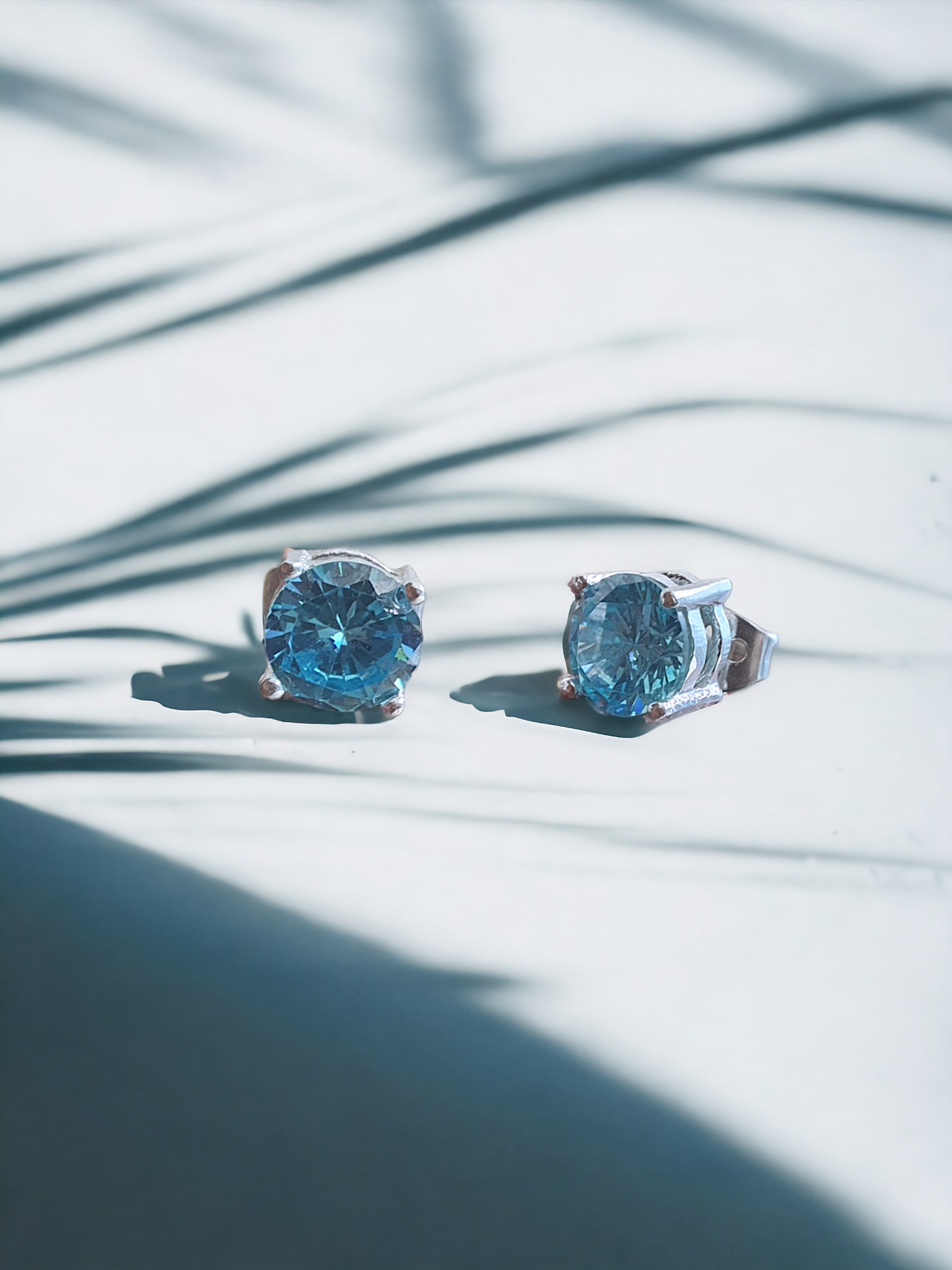 Lt. Blue Zircon Stud Earrings in Silver, crafted in brass with 6mm blue zircon stones. Total weight of 1.5g. Skin-friendly material, delivered in Sutra Designs' custom packaging