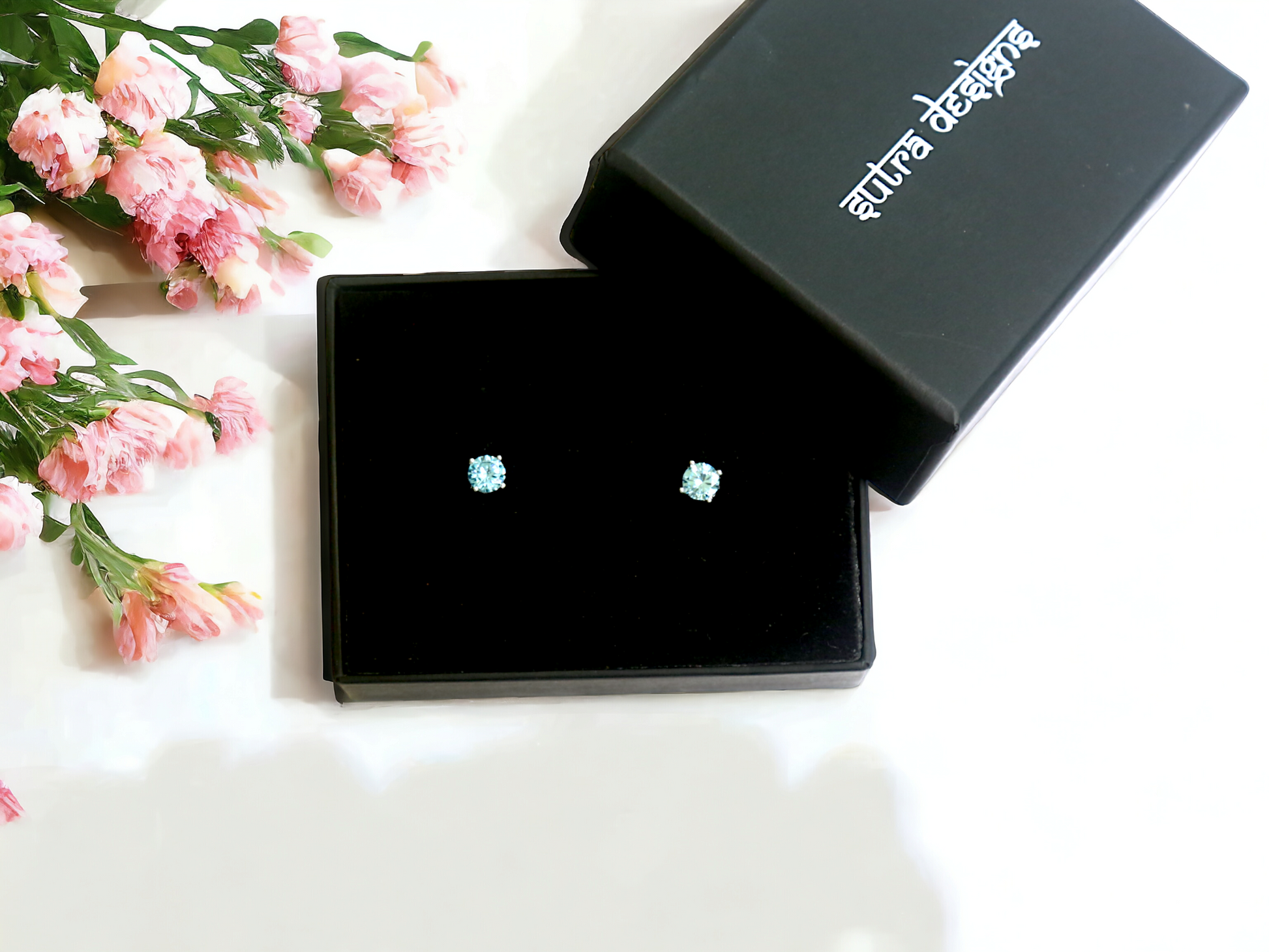 Lt. Blue Zircon Stud Earrings in Silver, crafted in brass with 6mm blue zircon stones. Total weight of 1.5g. Skin-friendly material, delivered in Sutra Designs' custom packaging